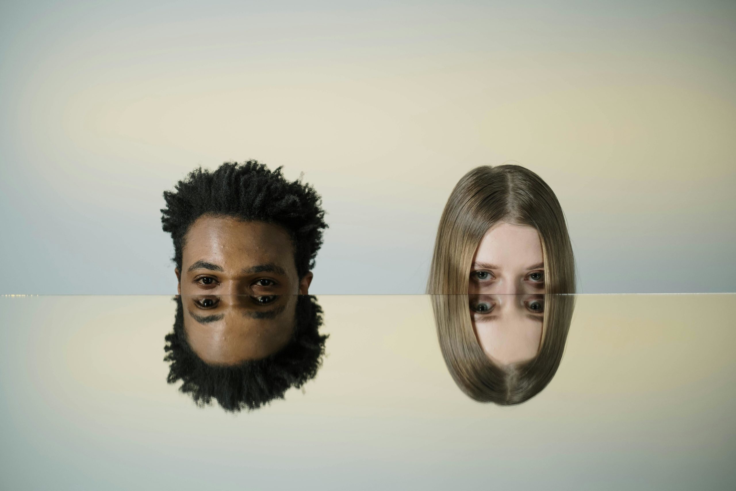 Conceptual illustration of co-parenting with a malignant narcissist, two mirrored faces symbolizing manipulation, control, and the emotional challenges of toxic co-parenting.